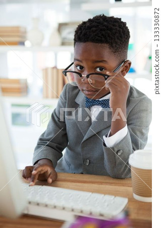 Portrait of businessman using computer at desk 133330872