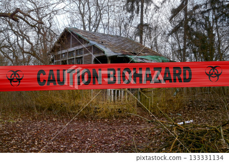 Caution biohazard cordon tape outside an abandoned cabin in the woods Caution biohazard cordon tape outside an abandoned cabin in the woods 133331134