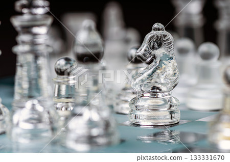 transparent glass chess on dark background, selective focus on horse piece, close-up 133331670