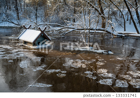 spring floods and ice melt in a small river, waterfowl feeder flooded as water level rises, Dobele spring floods and ice melt in a small river, waterfowl feeder flooded as water level rises, Dobele 133331741