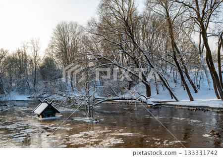 spring floods and ice melt in a small river, waterfowl feeder flooded as water level rises, Dobele spring floods and ice melt in a small river, waterfowl feeder flooded as water level rises, Dobele 133331742