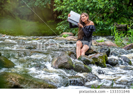 worried woman pulls out of water laptop that fell into river, remote holiday work accident worried woman pulls out of water laptop that fell into river, remote holiday work accident 133331846