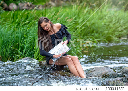 worried woman pulls out of water laptop that fell into river, remote holiday work accident worried woman pulls out of water laptop that fell into river, remote holiday work accident 133331851