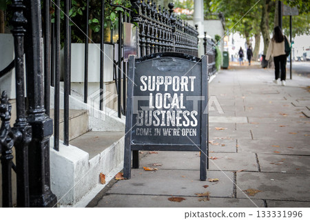 Support Local Business Sign on City Street. Community engagement and small business awareness in an 133331996