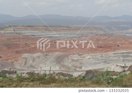 Coal mining in an open pit. Landscape with mountains and trees. Coal mining in an open pit. Landscape with mountains and trees. 133332035
