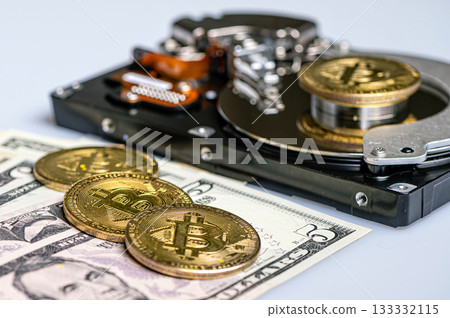 Bitcoin BTC coins, open hard drive and dollar bills, digital payment system concept 133332115