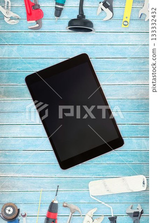 Tools and tablet on wooden background Tools and tablet on wooden background 133332432