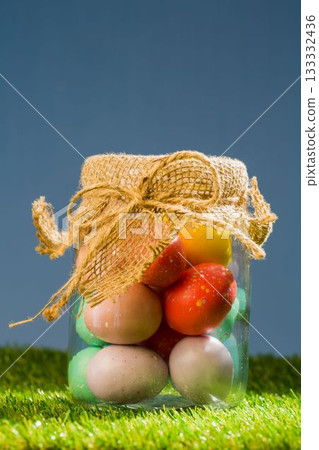 Easter eggs in jar on field 133332436