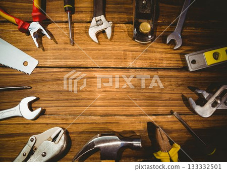 Assorted hand tools are lying on flat wooden tabletop in flat design, showing pliers and wrenches 133332501