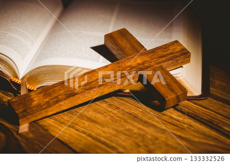 Close-up of cross kept on open bible Close-up of cross kept on open bible 133332526