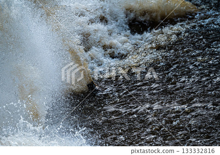close up of flowing water, rapid water splashes of an white water river or stream, bubbly water close up of flowing water, rapid water splashes of an white water river or stream, bubbly water 133332816