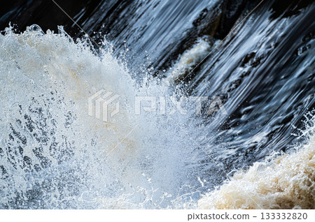 close up of flowing water, rapid water splashes of an white water river or stream, bubbly water close up of flowing water, rapid water splashes of an white water river or stream, bubbly water 133332820