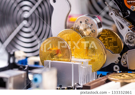 closeup of gold bitcoin on computer components background, technology and digital currency concept 133332861