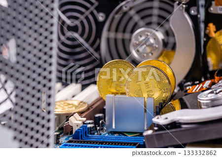closeup of gold bitcoin on computer components background, technology and digital currency concept 133332862