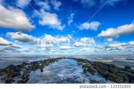 Expansive horizon under clear day with scattered clouds Expansive horizon under clear day with scattered clouds 133332893