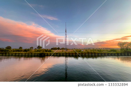 Tranquil twilight scene featuring reflective tower amidst natural Tranquil twilight scene featuring reflective tower amidst natural 133332894