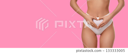 Hands on abdomen create a heart shape for body care 133333005