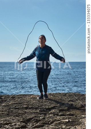 man with earphones and smartphone on beach 133334075