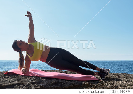 woman doing yoga on beach woman doing yoga on beach 133334079