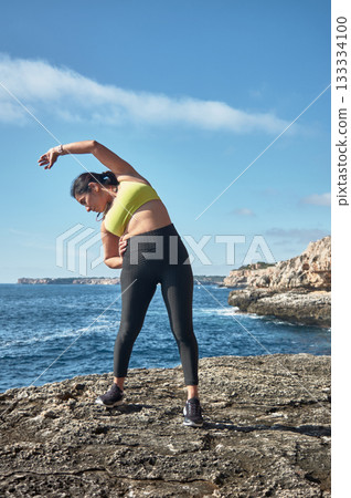 young woman doing yoga on the beach young woman doing yoga on the beach 133334100