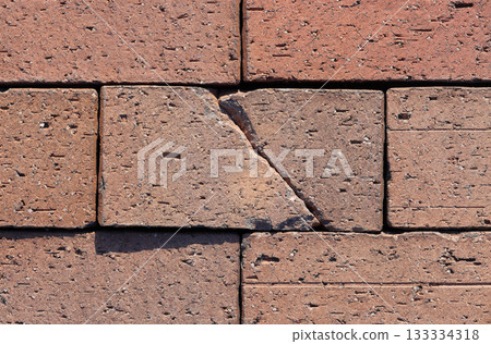 Damaged area of brick paving 133334318