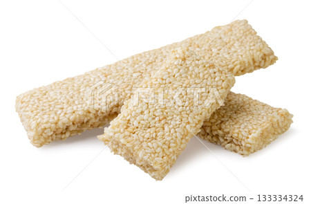 Sesame bars and halves, kozinaki close-up on a white. Isolated 133334324