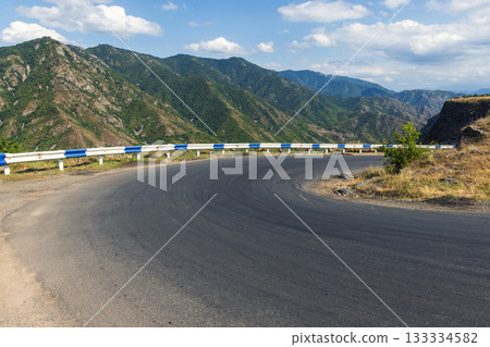 Mountain turn protected by blue and white guardrails. Armenia Mountain turn protected by blue and white guardrails. Armenia 133334582