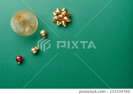 Gold ornaments and bow creating festive christmas and new year holiday flat lay Gold ornaments and bow creating festive christmas and new year holiday flat lay 133334769