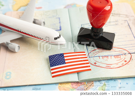 Approved Stamp visa and passport with US flag document to immigration at airport in country. 133335008