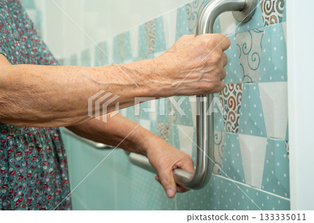 Asian elderly woman patient use toilet bathroom handle security in nursing hospital, healthy strong medical. Asian elderly woman patient use toilet bathroom handle security in nursing hospital, healthy strong medical. 133335011