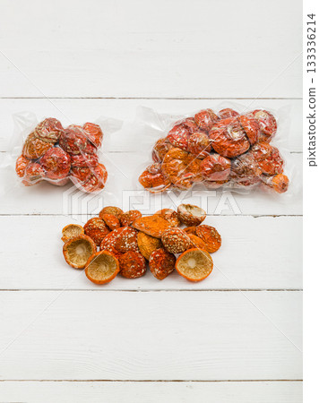 Dried fly agaric in a transparent package on a white background. 133336214