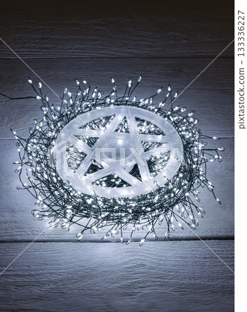 Garland of yellow LEDs on a brown wooden background. 133336227