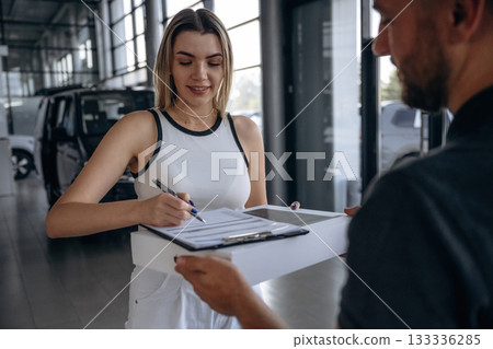 Hands, customer is bought the stuff. Woman is taking her order from delivery man, with the car Hands, customer is bought the stuff. Woman is taking her order from delivery man, with the car 133336285