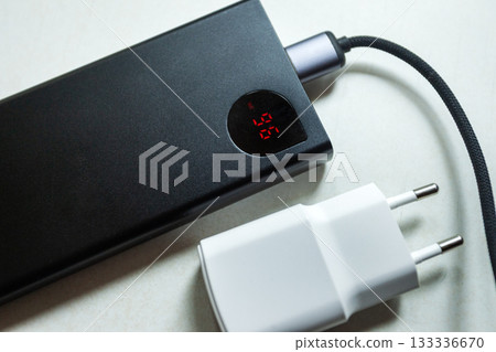 Power bank with display and white European smartphone charger 133336670