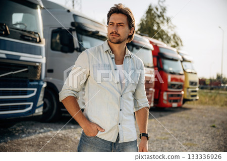 On the parking lot. Truck driver is near the transport outdoors 133336926