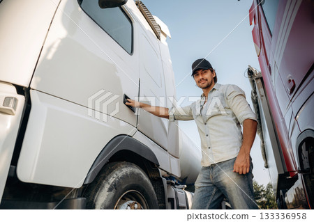 Opening the door. Truck driver is near the transport outdoors 133336958