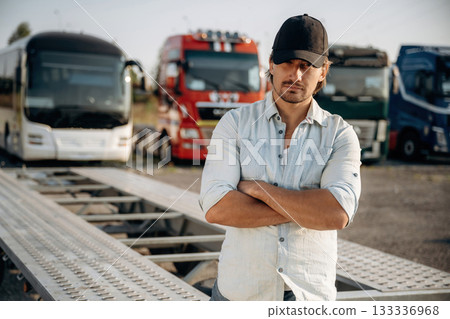 Truck driver is near the transport outdoors Truck driver is near the transport outdoors 133336968