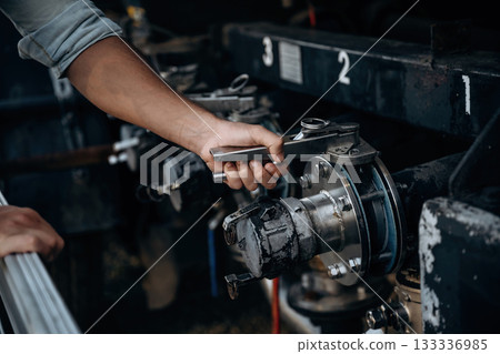 Close up view of man's hand that is checking the vehicle Close up view of man's hand that is checking the vehicle 133336985