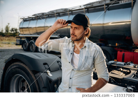 Fuel tank is behind. Truck driver is near the transport outdoors Fuel tank is behind. Truck driver is near the transport outdoors 133337003