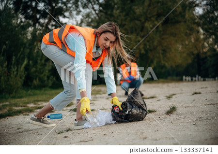 Woman volunteer is against trash pollution outdoors Woman volunteer is against trash pollution outdoors 133337141