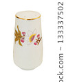 Ceramic salt shaker with a pattern of birdie isolated on a white background. Porcelain tableware. 133337502