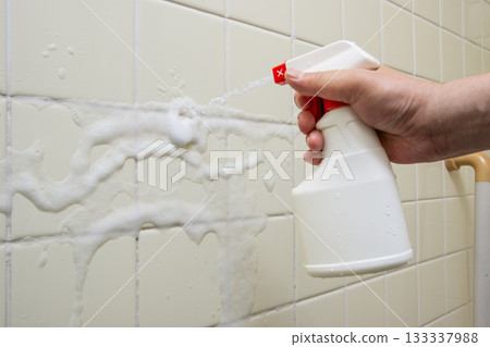 The hands of a worker removing mold from a bathroom The hands of a worker removing mold from a bathroom 133337988