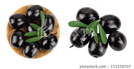 Black olives with leaves in wooden bowl isolated on a white background with full depth of field. Top view. Flat lay Black olives with leaves in wooden bowl isolated on a white background with full depth of field. Top view. Flat lay 133338707