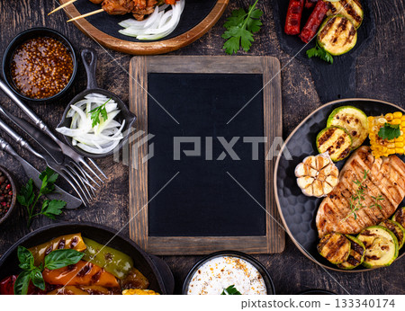 Assortment of grilled bbq meat and vegetables 133340174