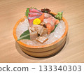 Assorted salmon, sea bream, and squid sashimi in a bucket 01 133340303