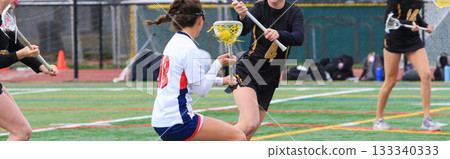 Girls Lacrosse Game With Action on the Field in Spring Season 133340333