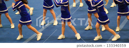 Youth Cheerleaders Perform on Blue Gym Floor at Competition 133340359