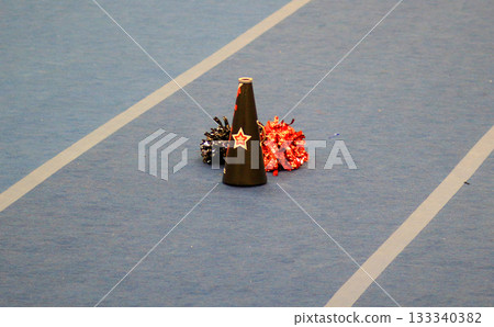 Cheerleading Accessories on a Gym Floor During Practice Session 133340382