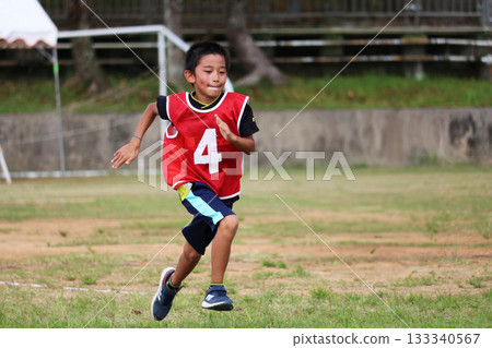 A child wearing number 4 A child wearing number 4 133340567