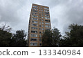 Cityscape of modern tall residential building in Moscow surrounded by trees under cloudy sky 133340984